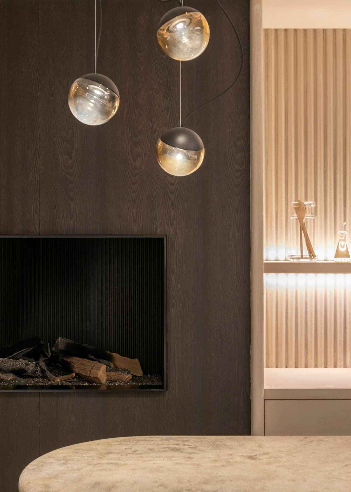 Sculptural pendant lighting above a styled dining setting